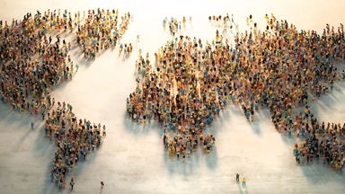 People standing in shape of world